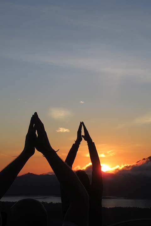 Sunrise yoga overlooking Batur volcano in Bali