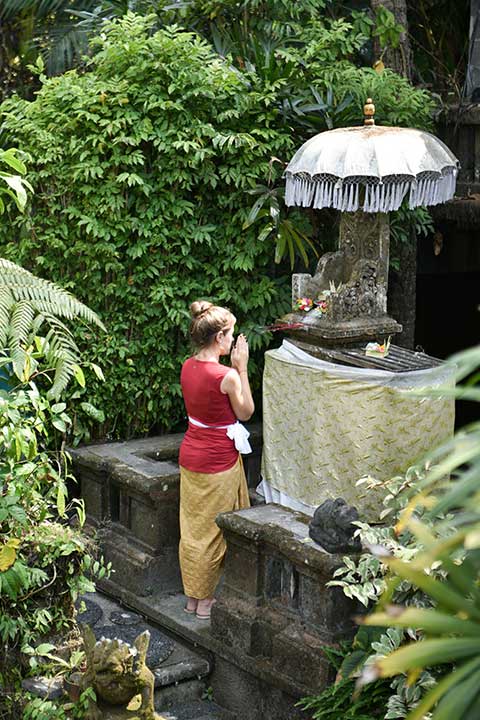 Oneworld guest praying in the small temple inside the resort